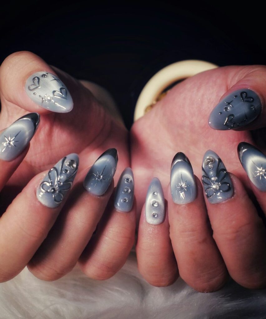 What Nail Shape Is Best for Your Fingers? A Guide to Choosing the Right Shape 2 Nail shape inspiration featuring long silver and black stiletto nails with artistic designs
