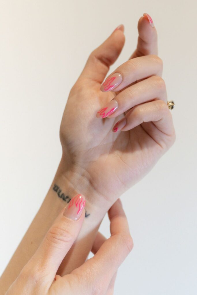 10 Easy Nail Art Ideas for Beginners You Can Try at Home 11 Easy Nail Art featuring light pink nails with delicate red floral decorations.