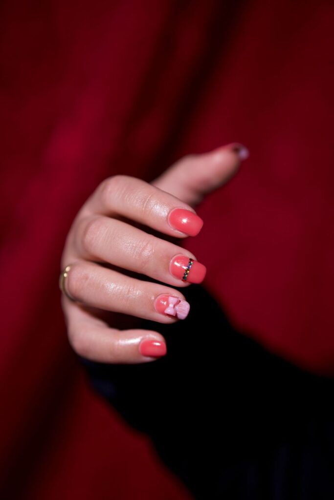 10 Easy Nail Art Ideas for Beginners You Can Try at Home 3 Easy Nail Art featuring bright pink nails with black French tips and decorative patterns.
