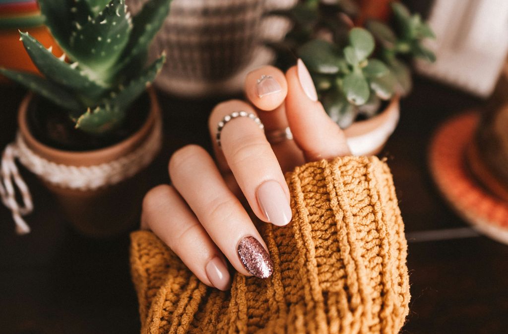 Best Nail Colors featuring elegant nude and peach-toned manicured nails with delicate nail art.