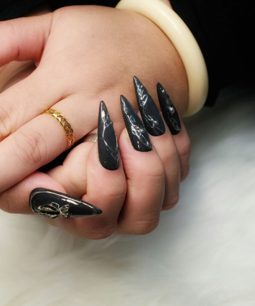 What Nail Shape Is Best for Your Fingers? A Guide to Choosing the Right Shape 5 Nail shape ideas featuring decorative silver and black nail art on long pointed nails