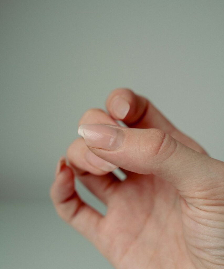 Why do my nails keep breaking, featuring short natural nails held close to the fingertips