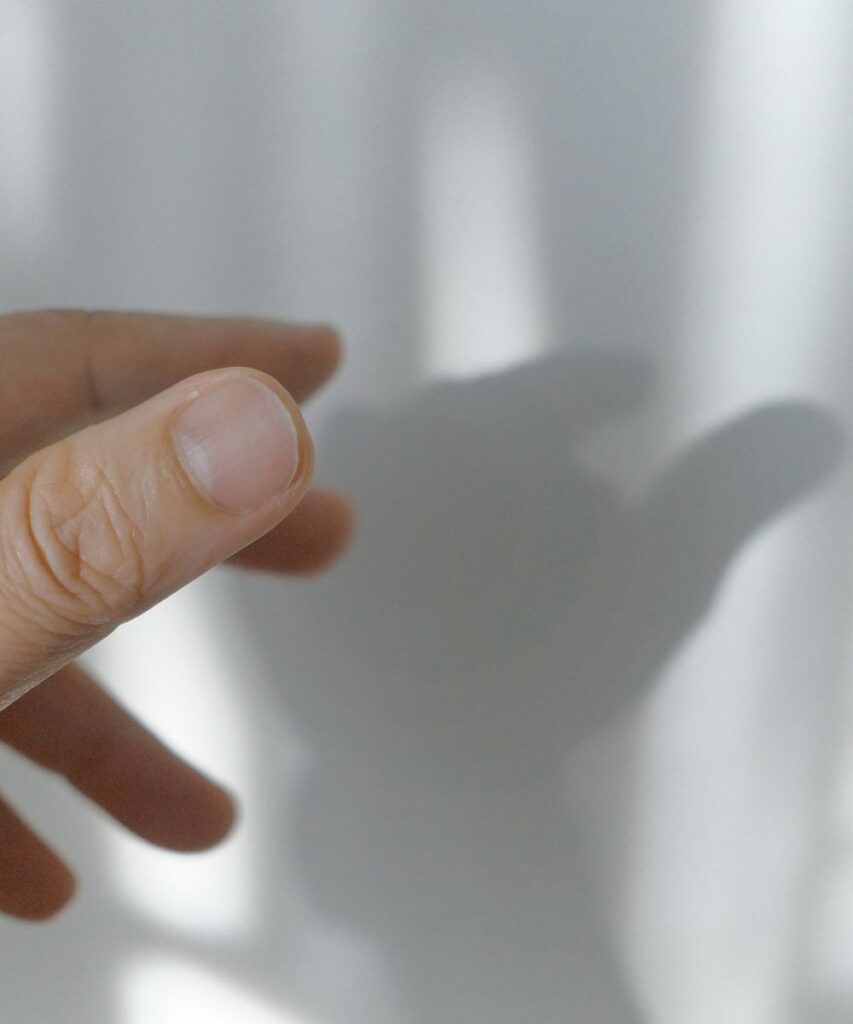 Why do my nails keep breaking, shown with a close-up of a natural fingernail and fingertip